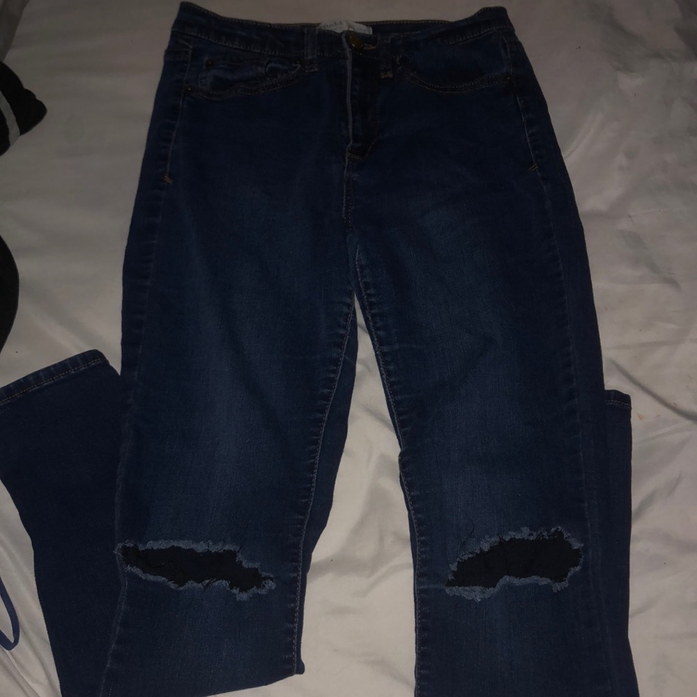 Ripped knee blue skinny jeans